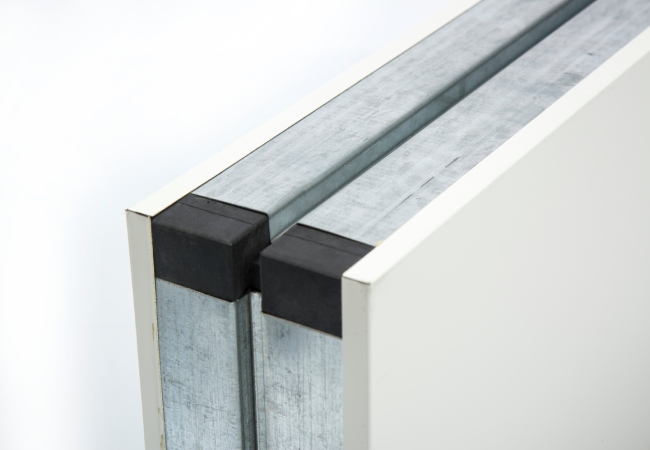 Real cleanroom wall panel edge detail showing metal skins and joint interface
