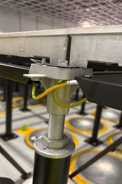 Wonclean Russia FAB 300 project photo showing raised floor pedestal support and conductive bonding detail in a semiconductor cleanroom